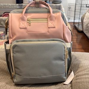Diaper bag with fold out changing pad/crib